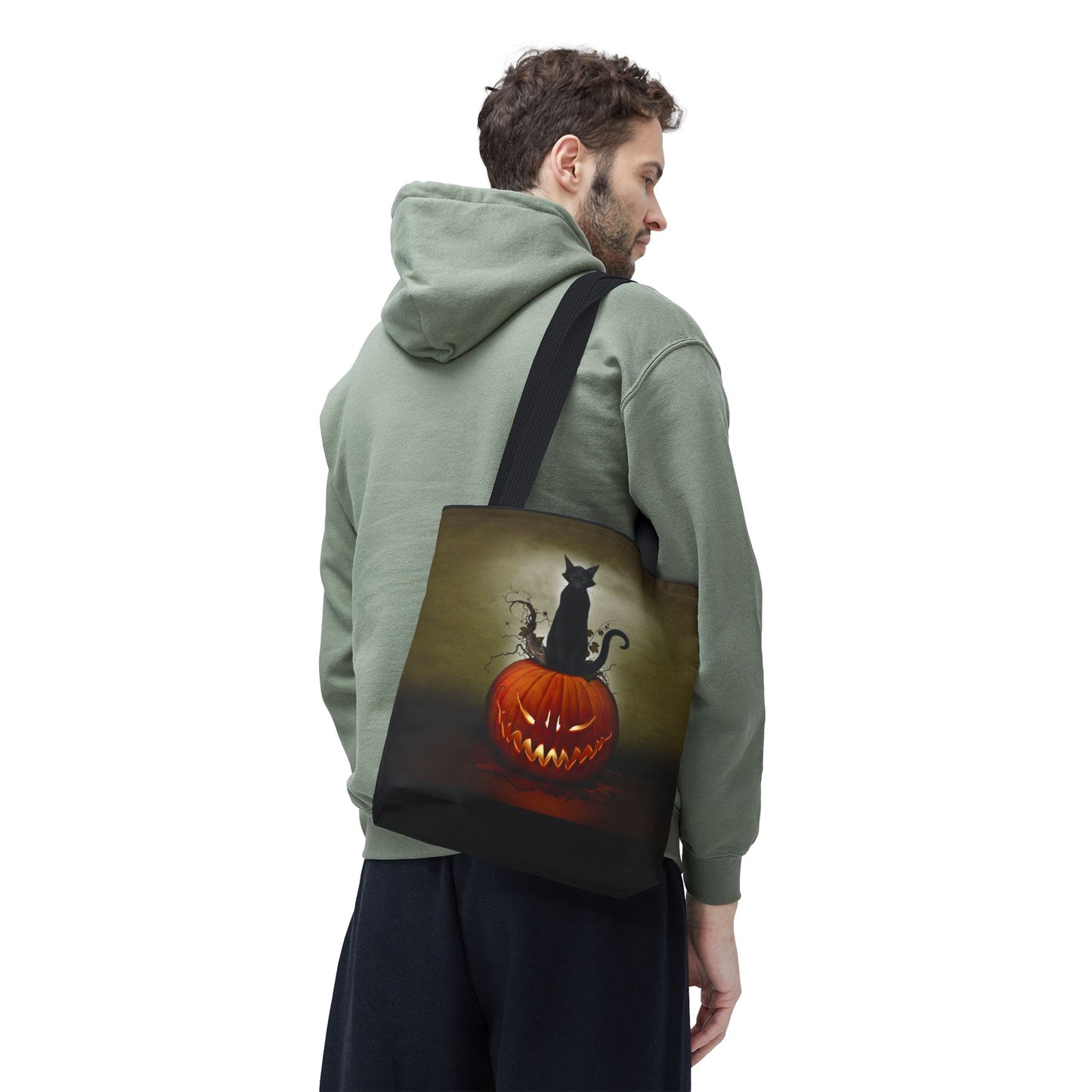 Halloween black tote bag — Cat O' Lantern all-over print, black cat perched on glowing jack-o-lantern