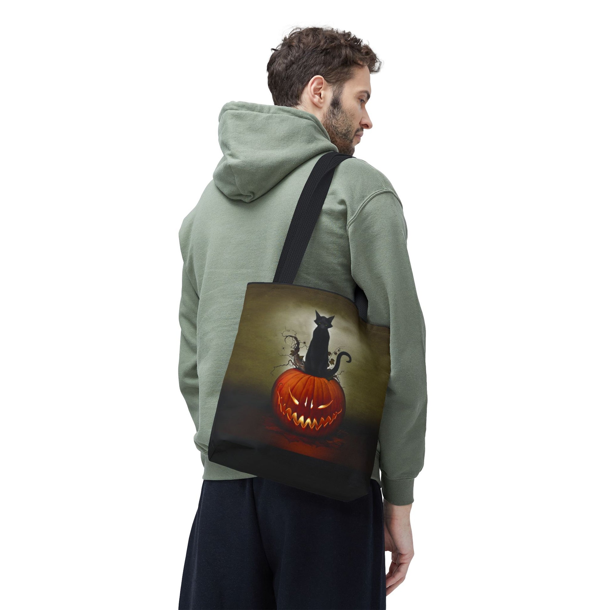 Halloween black tote bag — Cat O' Lantern all-over print, black cat perched on glowing jack-o-lantern